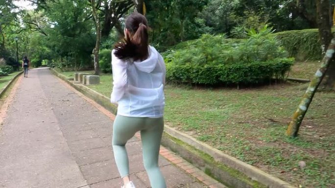 亚洲华裔年轻女子周末早上在公园跑步