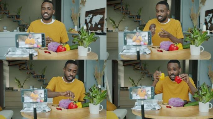 年轻人vlogger使用智能手机摄像头在家中录制有关厨房食物的视频