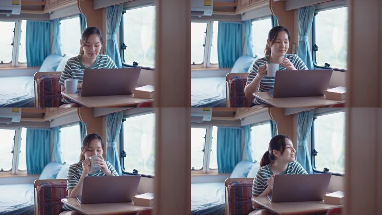 在露营车中使用笔记本电脑的年轻女子
