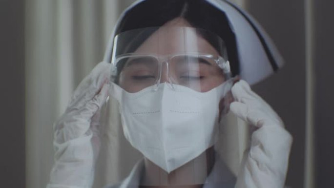 女护士应用面罩特写镜头戴护目镜面对镜头微