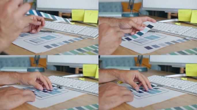 男性手部设计师的特写镜头为智能手机应用程序选择颜色，手持调色板和屏幕图片
