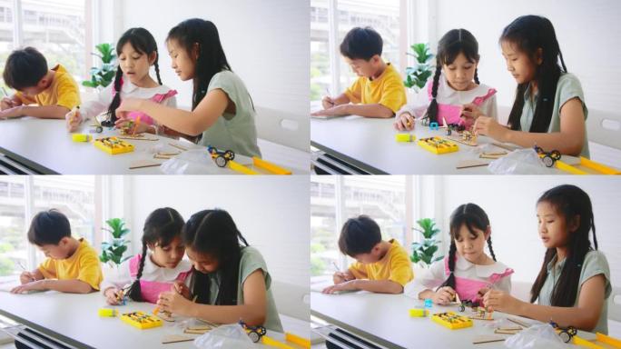 一组小学生学习机器人编程和算法思维培训班。小学教育STEM教育概念。