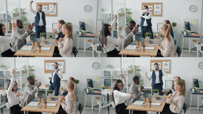 一群商人在工作台上跳舞，庆祝成功的商业协议