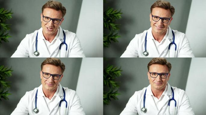 英俊的男医生在视频会议上与远程患者使用在线虚拟聊天。远程会诊医疗专业微笑远程医疗计算机应用视频通话冠