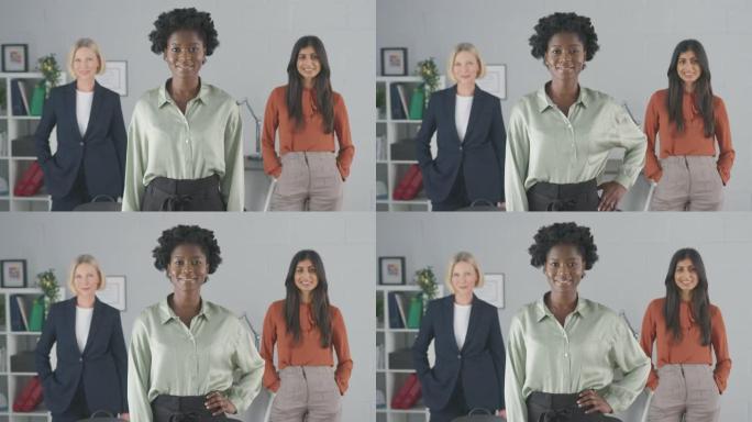 微笑的女性多种族商业团队站在办公室的肖像