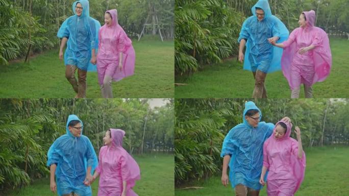 恋爱中的幸福夫妻的慢动作在花园里的雨中行走