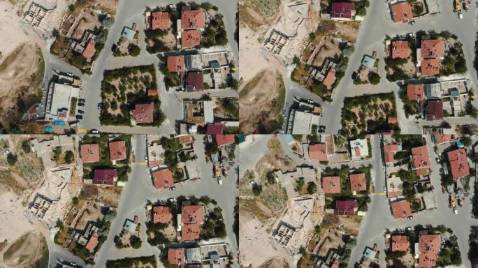 在夏季土耳其，俯视图无人机飞越美丽的阳光明媚的小镇，小镇上有房屋和方形城市街道。