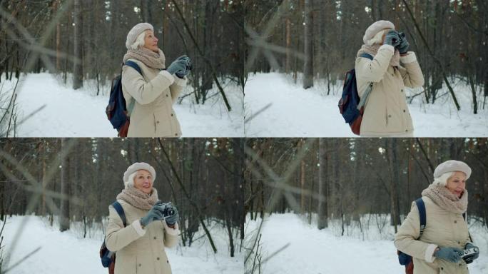 快乐的老年摄影师在冬季公园用专业相机拍照