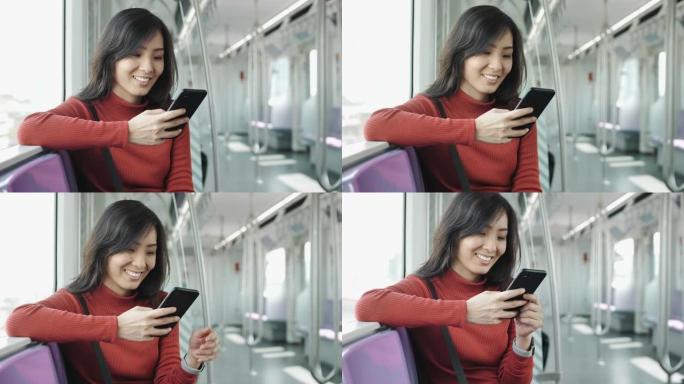 在地铁上使用智能手机的年轻女子