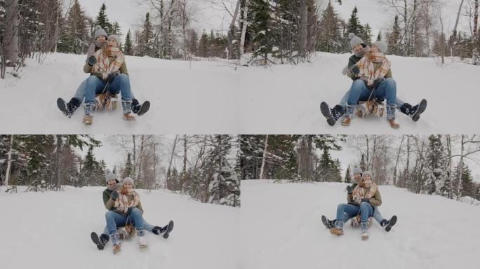 多莉拍摄了快乐的年轻女性朋友在冬天的树林中滑下雪橇的镜头