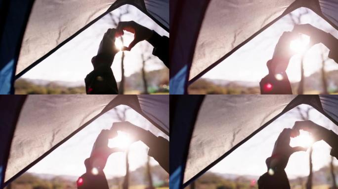 4k视频，一个女人用手在帐篷上做心形