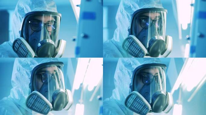 在实验室里，一名男性专家戴着防毒面具。流行病病毒科学概念