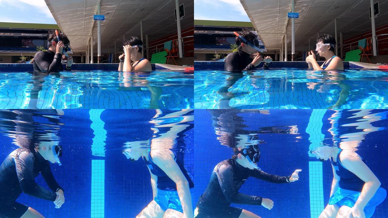亚洲中国成熟女子与她的教练在水中练习浮潜呼吸练习