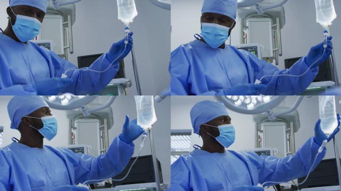 非裔美国男性外科医生穿着防护服在手术室里滴水