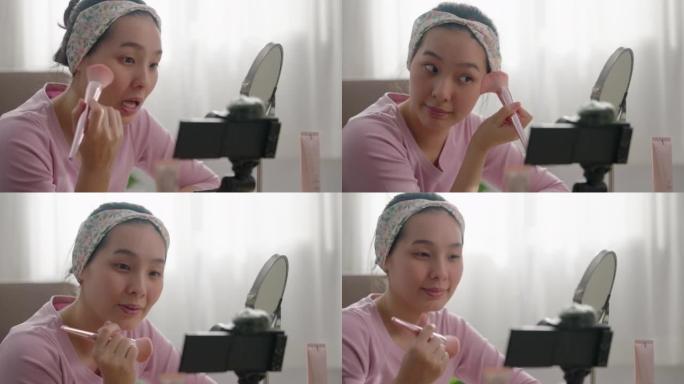 美丽的亚洲女人博主正在展示如何化妆和使用化妆品