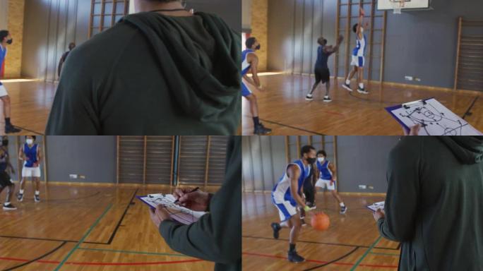 多元化的男子篮球队与教练手持剪贴板，戴着口罩进行比赛