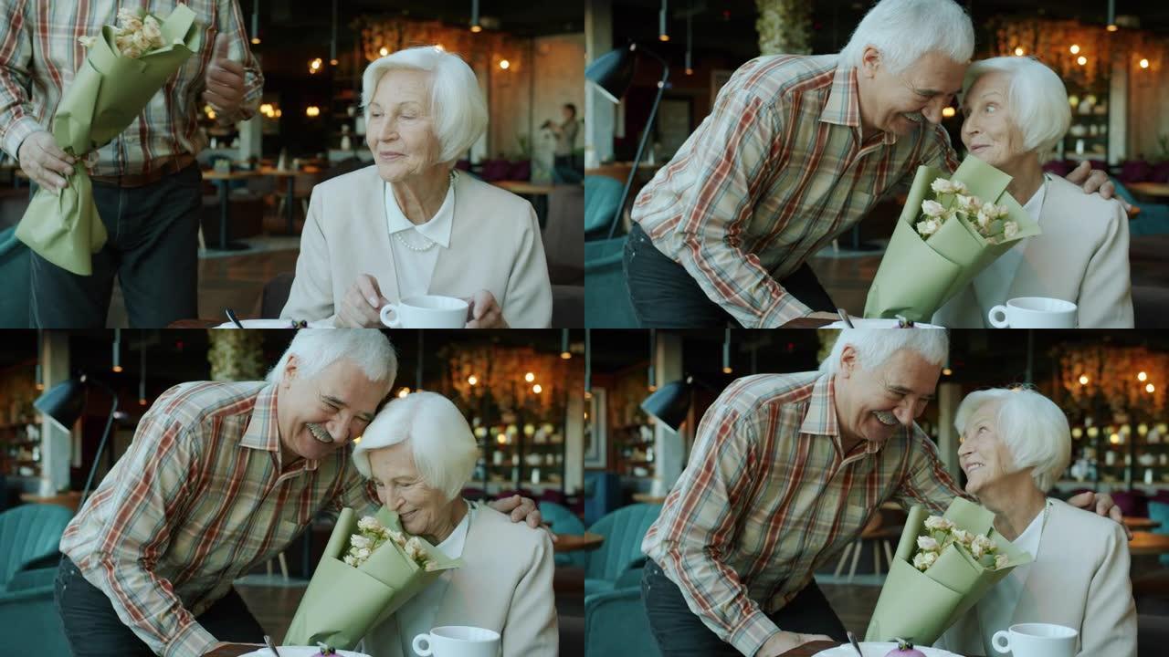 老年妇女在餐厅晚餐时从爱心男子那里得到鲜花的肖像