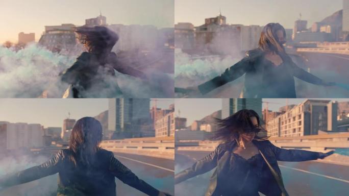 女人在日出时在城市与烟雾弹跳舞叛逆的女孩在街上享受舞蹈