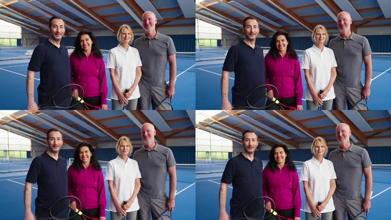 活跃的高级夫妇一起站在室内网球场上