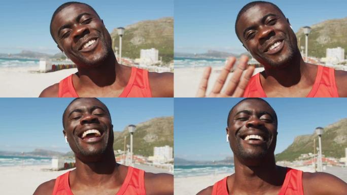 微笑的非洲裔美国男子的肖像，向相机挥手，在户外运动中休息