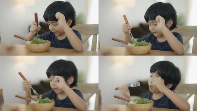 一个吃沙拉的男孩。
