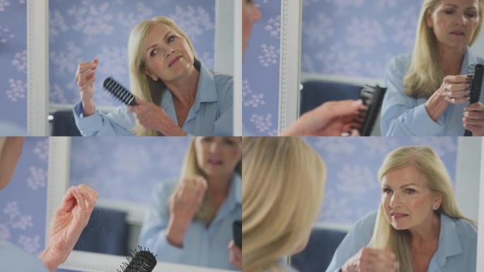 更年期成熟的女人在家浴室照镜子，刷牙并注意到脱发-慢动作拍摄