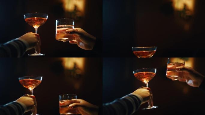 两个人的特写镜头在酒吧或迪斯科俱乐部用鸡尾酒欢呼。