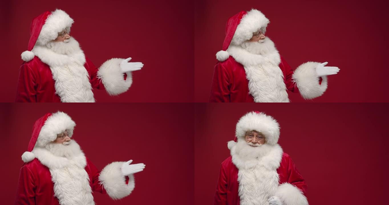 红色背景上的圣诞老人显示了用手链接的复制空间