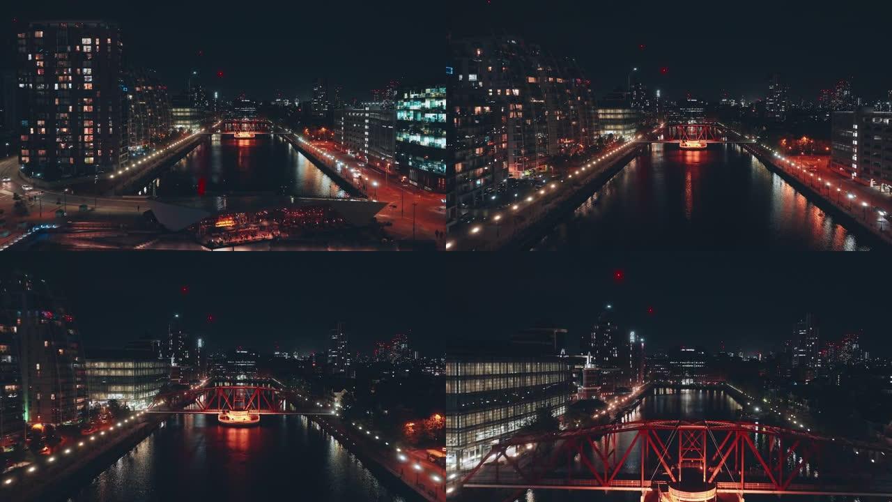 曼彻斯特夜间索尔福德码头的照明人行天桥视图