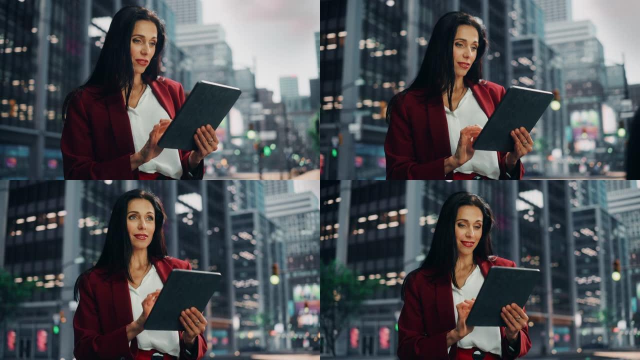 一个迷人的成年女商人在大城市的街道上使用平板电脑的肖像。自信的经理在去办公室的路上与网上的人联系，发
