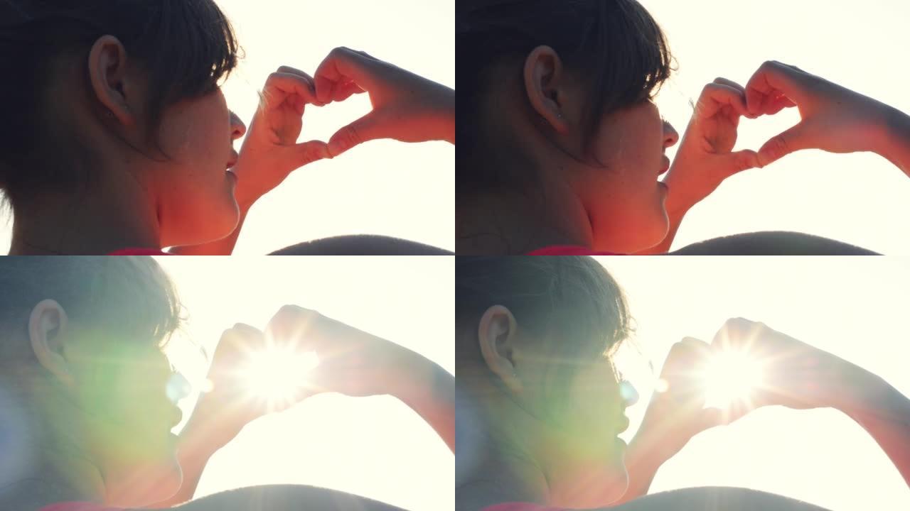 4k视频片段，一名年轻女子在外面用手指露出心形