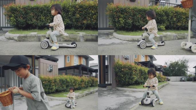 一个小女孩骑着一辆没有头盔的蹒跚学步的踏板车，微笑着。