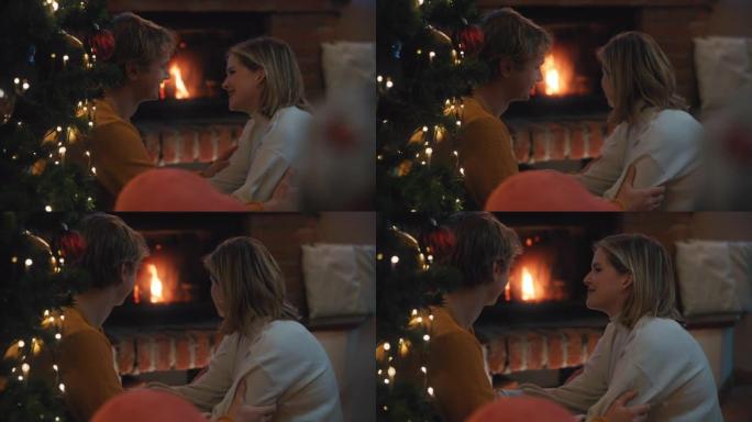 SLO MO DS年轻夫妇在家里的壁炉前庆祝浪漫的圣诞节