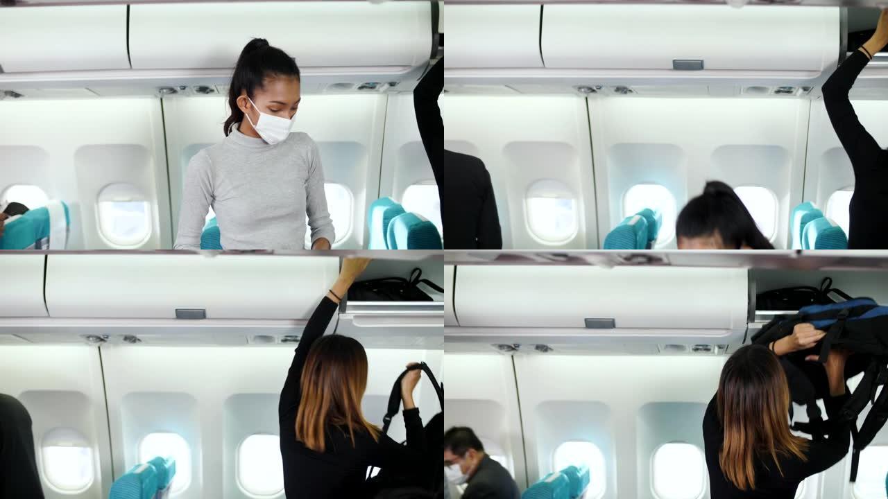 女人戴着口罩将行李放到飞机机舱