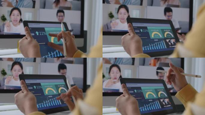 在视频会议上关闭亚洲妇女的手握平板电脑会议