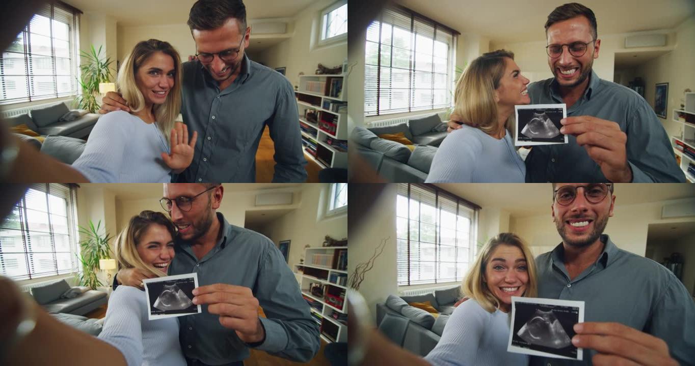 幸福微笑的已婚夫妇的真实照片正在在家中使用智能手机向朋友或家人拨打视频技术，并显示超声波以宣布他们未