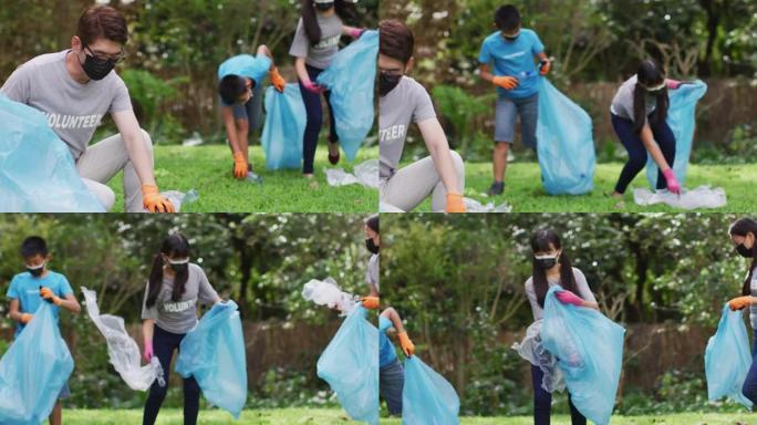 亚洲父母，儿子和女儿戴着口罩，拿着垃圾袋收集塑料垃圾