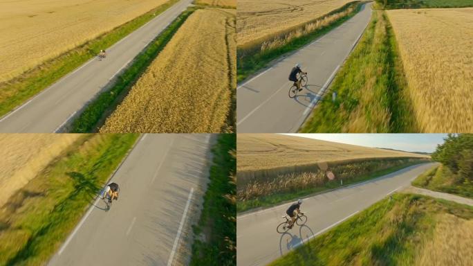 空中运动员骑自行车穿越乡间公路
