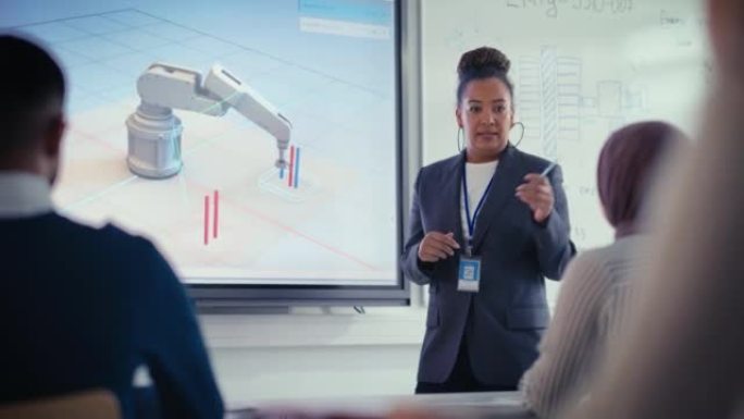 黑人老师在大学机器人讲座上向学生解释工程学。她使用投影屏幕。一组工程师聆听有关机械臂程序开发的讲座。