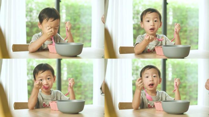 1-2岁的小男孩自己吃食物