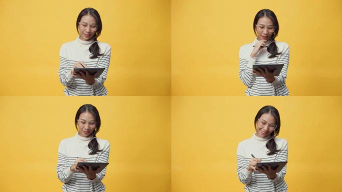 快乐迷人的亚洲学生女士拿着平板电脑，指着复印空间享受看书数字网上购物。