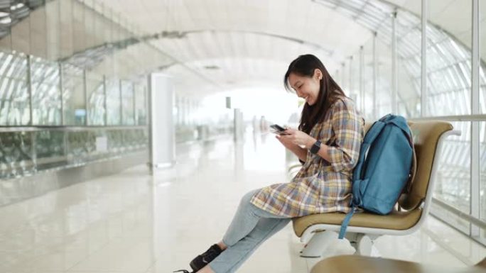亚洲妇女在机场使用智能手机
