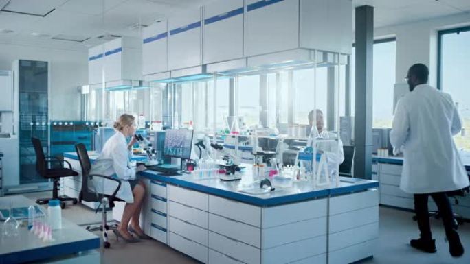医学实验室与不同的专业科学家团队一起使用显微镜，计算机。开发药物，DNA基因编辑技术，用高科技设备进