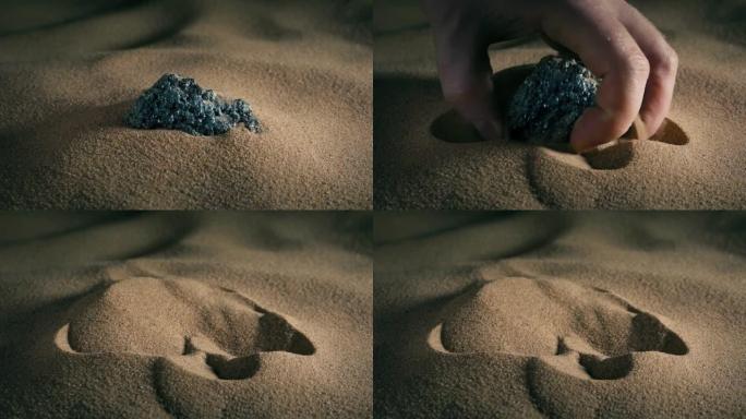 从沙子中捡起的矿物岩石-贵金属