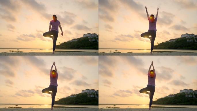 亚洲运动女子在沙滩上练习瑜伽