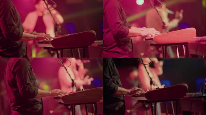 摇滚乐队音乐家在音乐节上演奏钢琴的特写镜头。