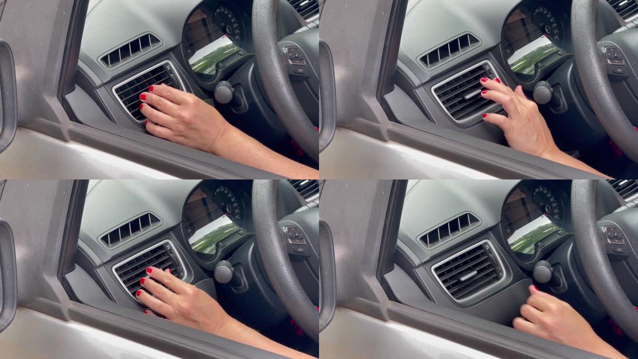 一名司机女士的手转动通风格栅。特写。4k分辨率。