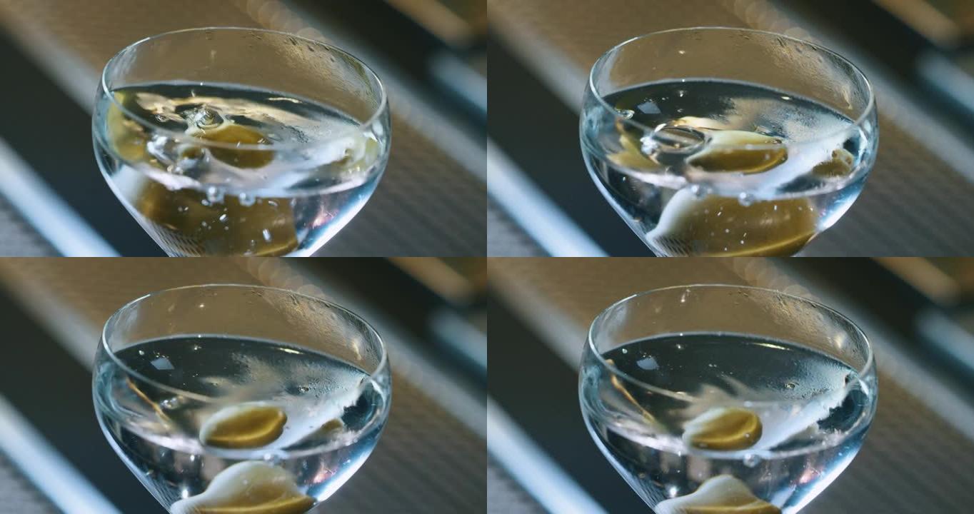 专业调酒师的特写镜头正在酒吧或迪斯科俱乐部为顾客提供精英酒精鸡尾酒。