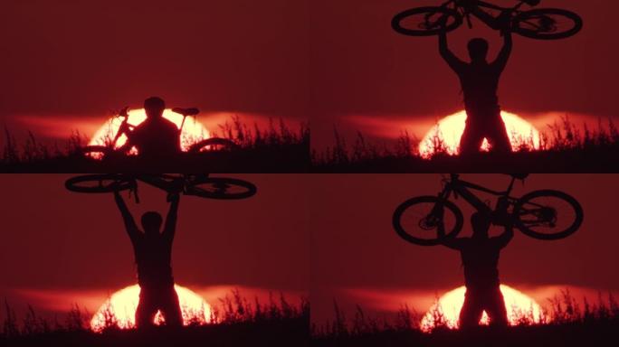 骑自行车的人在日落时举起自行车的剪影