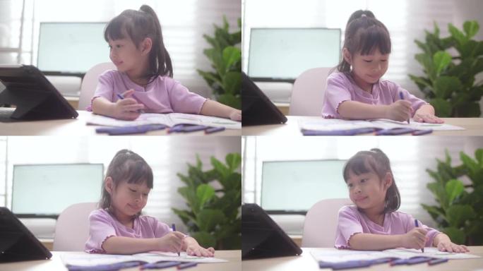亚洲女儿在家学习数字平板电脑上的在线课程
